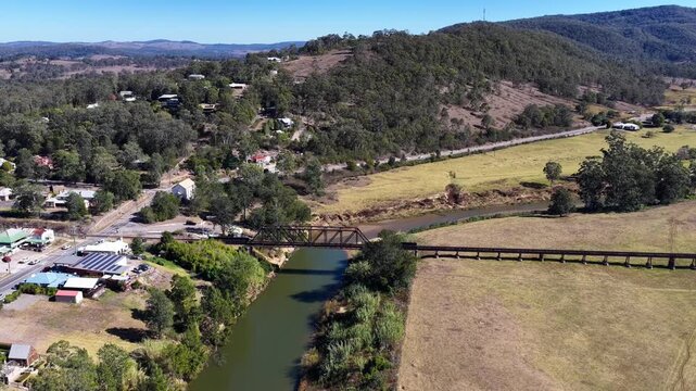 Aerial video flying over the Paterson railway bridge and along the Hunter River in New South Wales Australia.