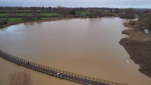 Low Aerial Pass Over Flooded Footbridge and Walkway in Wicksteed Park Kettering Northamptonshire England