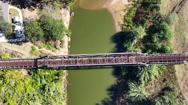 Aerial downward view video flying over the Paterson railway bridge spanning the Hunter River in New South Wales Australia.