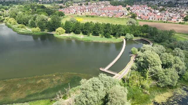 Aerial View of Curved Path Around Lake with English Suburban Housing Development