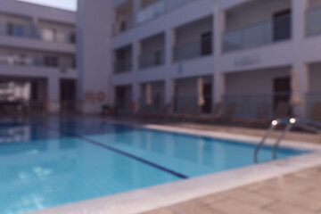 Fototapeta premium Swimming pool in a luxury resort at daytime with soft background blur.