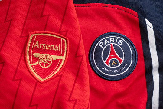 Ukraine, Kyiv - May 8, 2026. Close-up of Arsenal and Paris Saint-Germain football jerseys showcasing club crests and vibrant team colors.