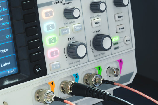  Digital oscilloscope displays multiple colored waveforms. Blue and purple traces indicate electrical data
