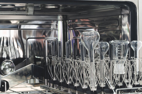 Laboratory chemical glass after washing in a special washing machine with the door open.