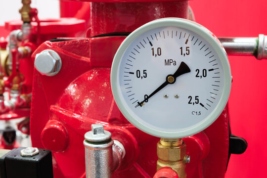 Fire-fighting equipment, Red tanks, pipes and pressure gauges for measuring the pressure of fire-fighting liquid or foam.