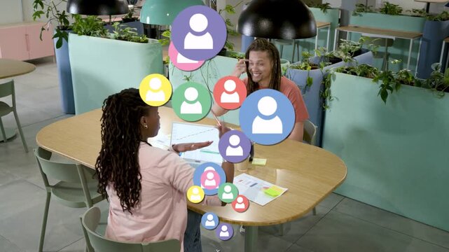 Woman marking business plan, man smiling, avatars rising between them visualizing team links