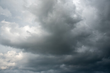 Obraz premium Dark gray sky cloudy environment. Meteorology danger windstorm disasters climate. Dramatic dark storm rain clouds black sky background. Dark cloudscape storm disaster gloomy gray cloud sky. Nimbus