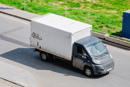 cargo van Fiat Ducato driving on a paved road, above front side view