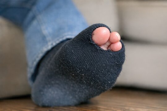 Close-up shot of human feet on a table, possibly preparing for pedicure or foot massage