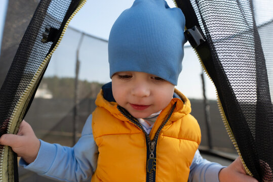 Toddler boy playing on trampoline with joy