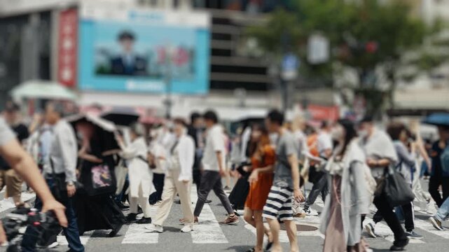 Anonymous crowd of people walking on city crosswalk