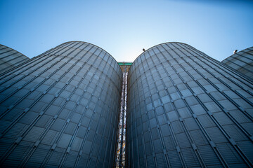 industrial grain silos and processing tower at agricultural facility © Amatis Art