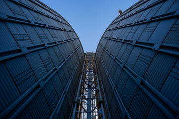 industrial grain silos and processing tower at agricultural facility © Amatis Art