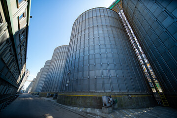 Industrial grain silos and processing tower at agricultural facility © Amatis Art