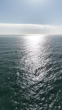 Top View Slow motion looping c ripples and wave, Refraction of sunlight top view texture sea side, Foaming and Splashing in the Ocean, Sunny Day, Slow Motion. Halkidiki, Greece. Veiw from drone