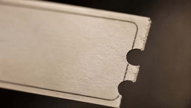 closeup paper ticket edge with perforation and texture detail