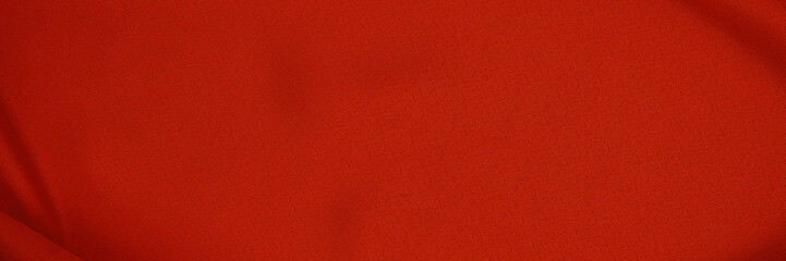 Fototapeta premium Bright red fabric shows texture and color under even lighting in a neutral space