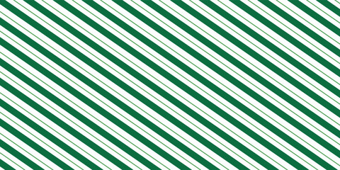 Obraz premium Christmas seamless pattern. Red and green diagonal stripes background. Candy cane repeating decoration wallpaper. Winter holiday lines backdrop. Xmas peppermint present wrapping print design. Vector