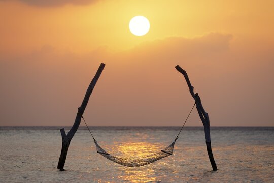 Sunset, Hammock on stilts over the sea, Indian Ocean, symbol for relaxation, recreation, vacation, Summer Island, North Mal&eacute; Atoll, Maldives