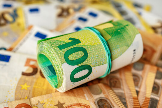 Euro cash flat composition with bundled 100 euro bills on top of mixed denominations. Concept finance and savings.

