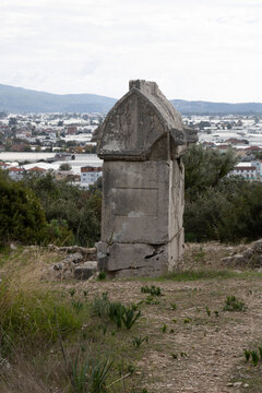 Ancient sarcophagus with modern city and greenhouses at the Ancient city of Xanthos at the Lycian way