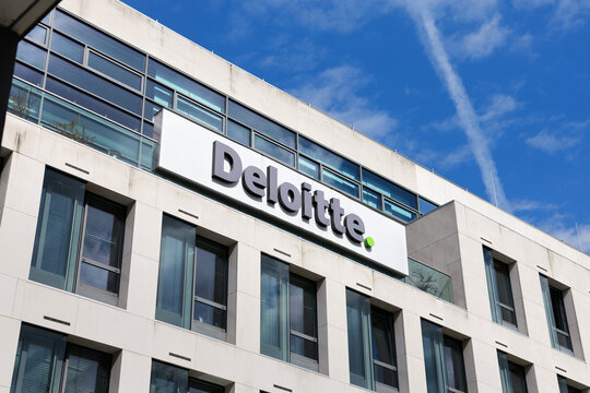 MUNICH, GERMANY - 20. April 2026: Deloitte logo sign on office building exterior. Modern facade of the employer during daytime. Multinational accounting and consulting firm.