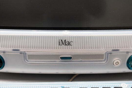 MUNICH, GERMANY - 21. April 2026: Apple Computer iMac G3 close-up of logo sign. Consumer product designed by Jonathan Ive and released in 1998.