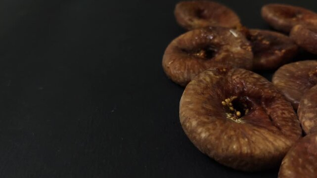 Dry fruit fig on black background backdrop, seeds blackboard with copyspace space for text placeholder template, figs are arranged in side on alpha channel