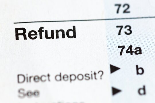 Closeup of United States personal tax form, focus on the word Refund