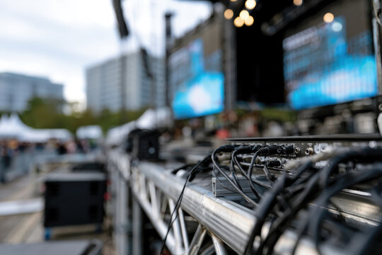 Close-Up Artistic View of Concert Equipment, Cables and Stage Monitors, Intricate Technical Details of Live Music Production, Behind-the-Scenes Performance Setup, Cinematic Lighting and Texture Focus 