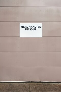 Merchandise Pick-up sign on metal loading dock door, Washington, USA