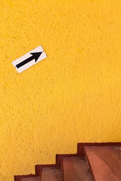 Arrow pointing up on bright yellow wall, Cancun, Yucatan Peninsula, Quintana Roo