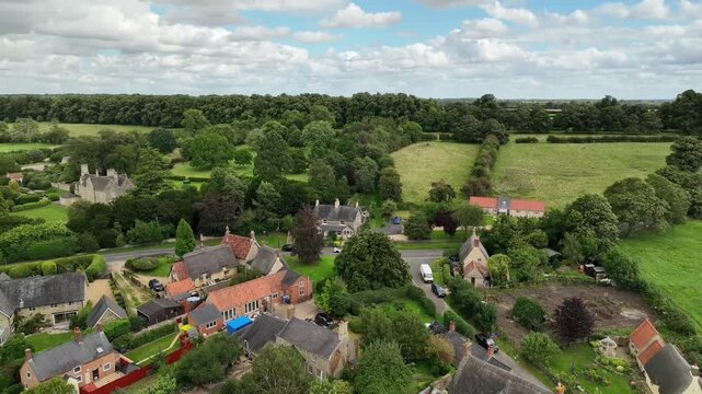 Aerial Drone View of Stone Cottages in Warkton Village Northamptonshire English Countryside