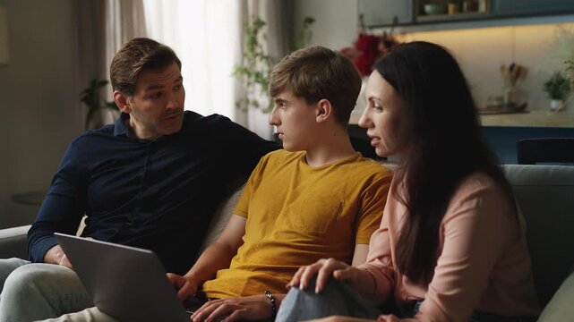 Adolescent son and his parents using a laptop to register for an online course