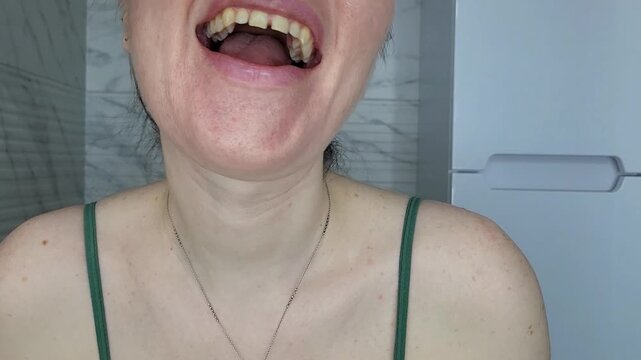 Young woman cleaning her teeth carefully, morning bathroom routine and dental disease prevention amalgam filling