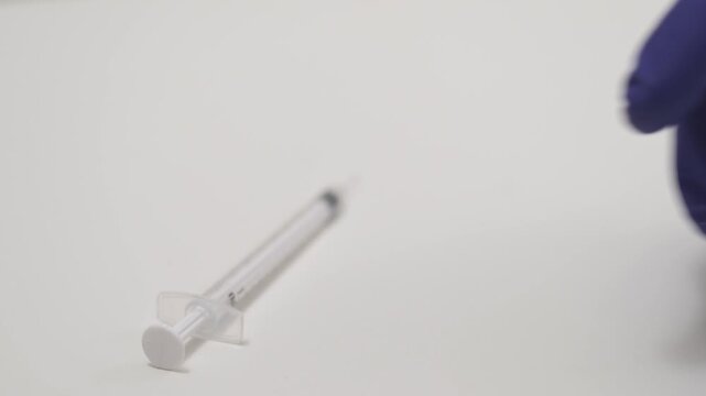 A syringe is placed next to a vial labeled hantavirus. The focus is on the contents and tools needed for vaccination against the hantavirus infection.