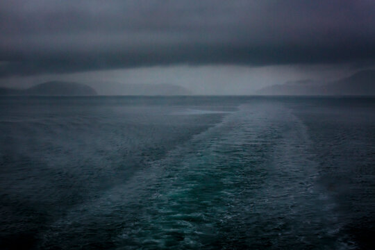 Boat wake behind the San Juan Islands ferry, low cloud and a stormy outlook.