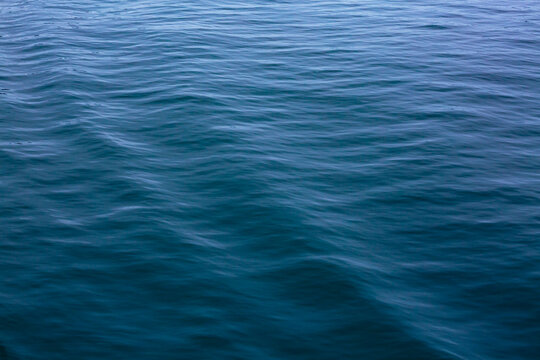 Motion blurred ocean waves, water surface, windblown 