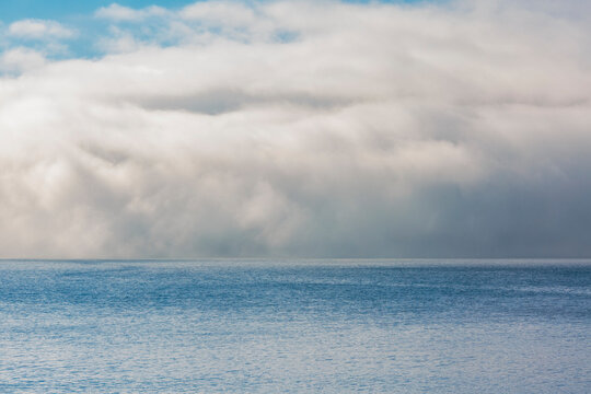 Fog and clouds clearing on East Sound, Orcas Island.