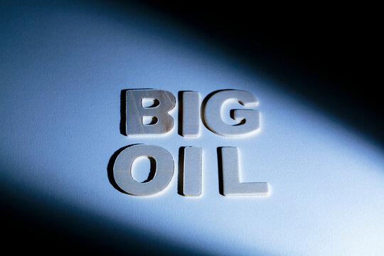 Big Oil sign, lettering on a blue surface, shadows, studio shot
