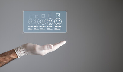 Fototapeta premium Doctor hand with a patient satisfaction rating. Feedback