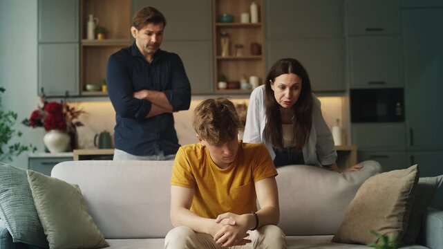 Displeased parents reprimanding their sad teen son, parental pressure and stress
