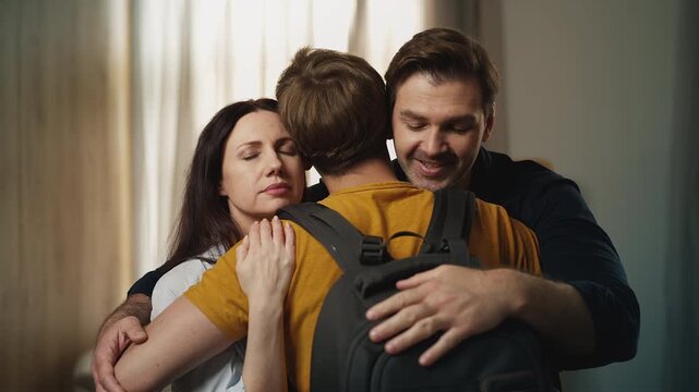 Parents embracing their teen son as he leaves for college, emotional farewell