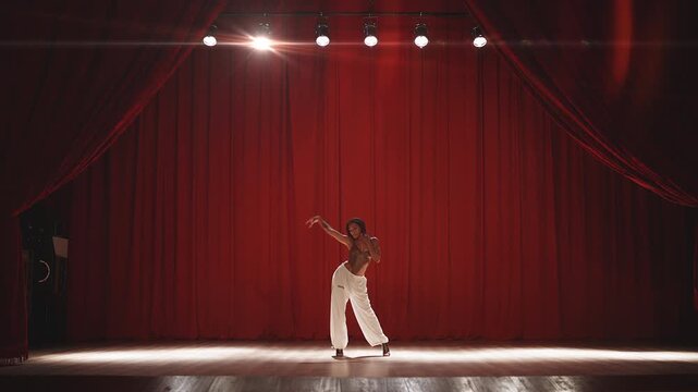 Female heel dancer expressing confidence during rehearsal on theater stage