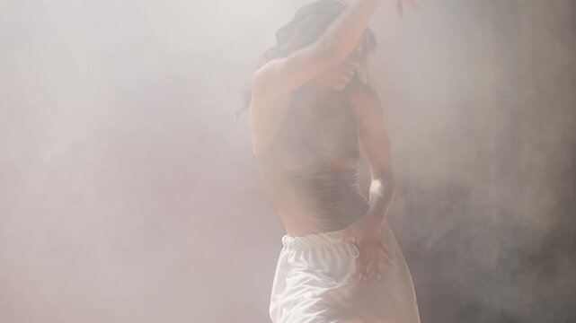 African American woman dancing on stage, expressing sensuality and femininity