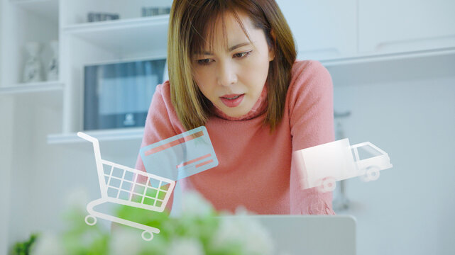 Young Asian woman arranging checkout delivery during online shopping with digital payment and ecommerce lifestyle concept