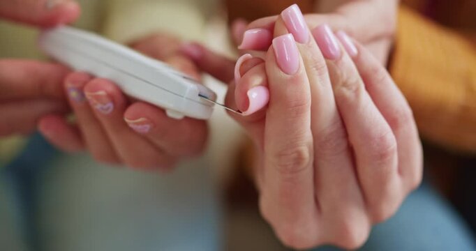 Person checking blood sugar level with a lancet device