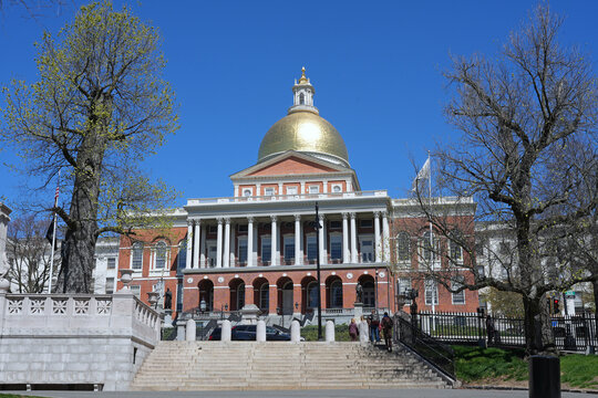 Massachusetts State House viewed from across Beacon Street, with steps leading up from Boston Common