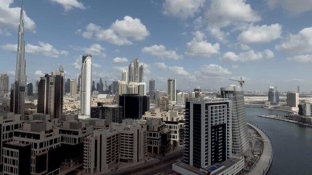 Dubai Downtown skyscrapers with city river at sunset