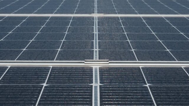 Bifacial photovoltaic solar panels surface with visible silicon cells. High efficiency modules at industrial renewable energy farm for sustainable power generation and electricity yield.